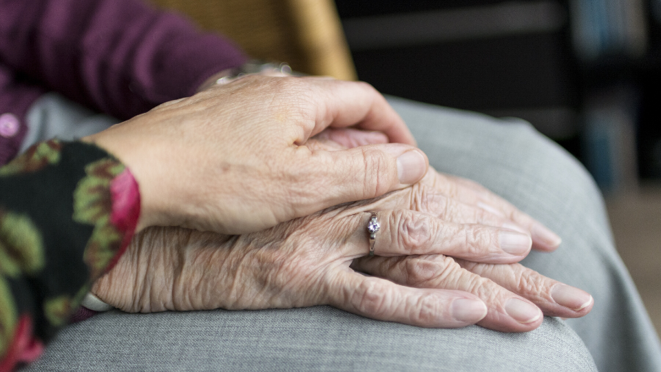 elderly person holding hands -care