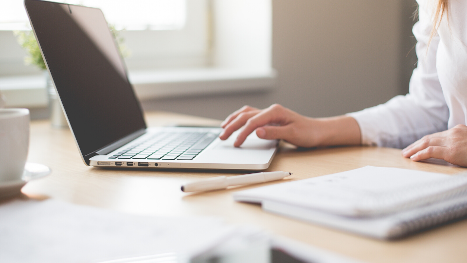 female typing at laptop. Work in office